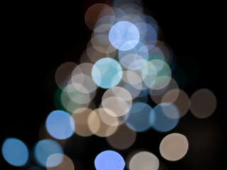 Abstract bokeh night light background, blurred lights traces from cars on road, defocused city traffic on street at night