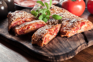 Italian stromboli stuffed with ham, salami and cheese