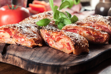 Italian stromboli stuffed with ham, salami and cheese