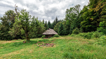 Old wooden hut or cabin in the mountain meadow Carpathians