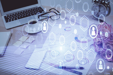 Computer on desktop with social network hologram. Double exposure. Concept of international people connections.