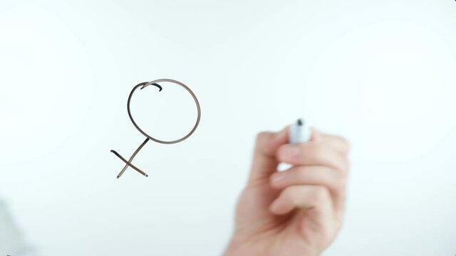 Video of man drawing gender symbols
