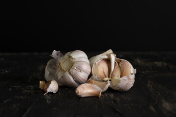 white bulb garlic on table with dark background