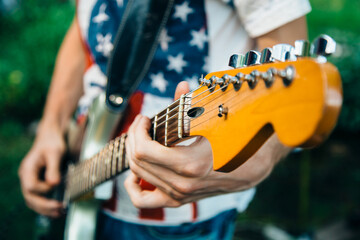 man playing guitar at black background