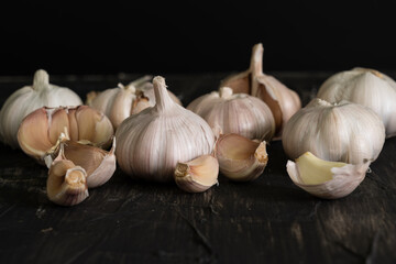 white bulb garlic on table with dark background