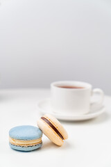 macarons on background tea Cup on a white table