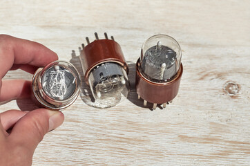 vacuum glass electronic retro light bulb on the wooden background