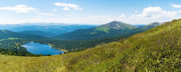 Fototapeta na wymiar The view from the top of the mountain. Light Lake in the Ergaki Nature Park. Panorama of the distant Siberian mountains