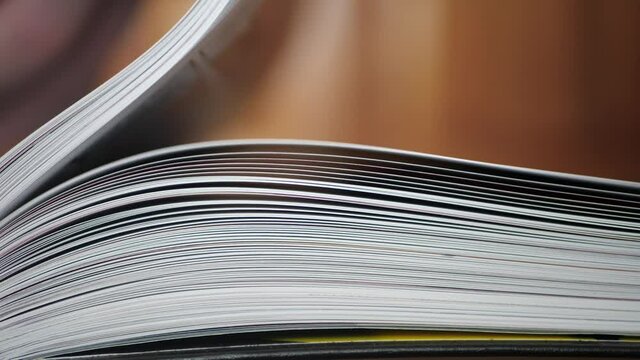 Close-up of a comic book, book pages. Hand turning pages in a Slow Mo. Pages falling in a Slow Mo