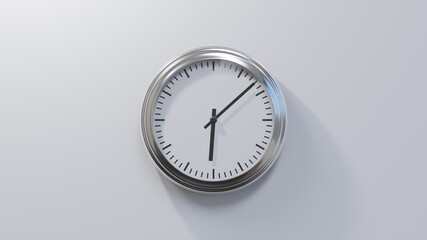 Glossy chrome clock on a white wall at eight past six. Time is 06:08 or 18:08