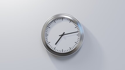 Glossy chrome clock on a white wall at thirteen past seven. Time is 07:13 or 19:13