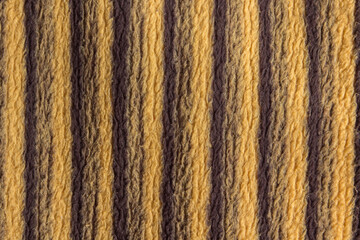 Brown and yellow fabric texture background with straight lines. Striped blanket.