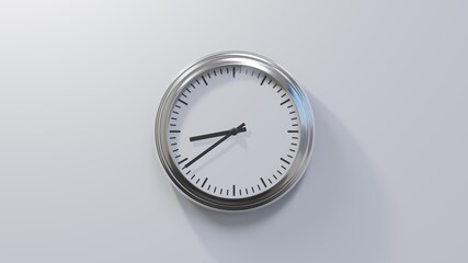 Glossy chrome clock on a white wall at thirty-nine past eight. Time is 08:39 or 20:39