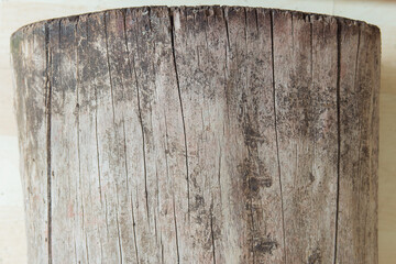 Side view of a cracked log on a parquet ground. Old wood texture background.