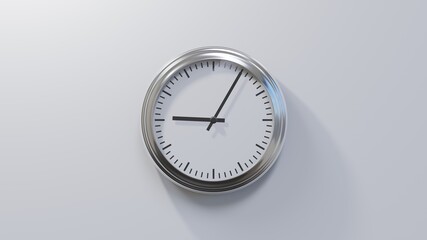 Glossy chrome clock on a white wall at five past nine. Time is 09:05 or 21:05