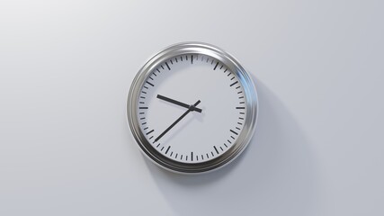 Glossy chrome clock on a white wall at thirty-eight past nine. Time is 09:38 or 21:38