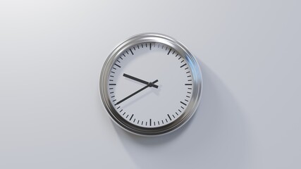 Glossy chrome clock on a white wall at twenty to ten. Time is 09:40 or 21:40