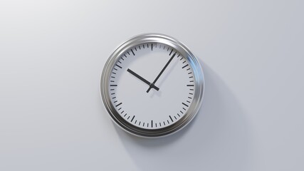 Glossy chrome clock on a white wall at six past ten. Time is 10:06 or 22:06