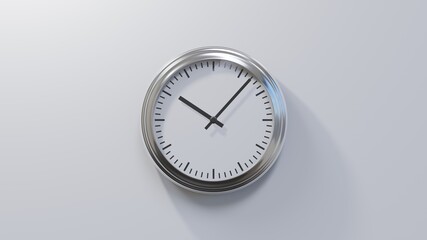 Glossy chrome clock on a white wall at seven past ten. Time is 10:07 or 22:07