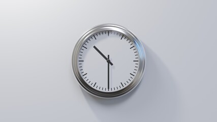 Glossy chrome clock on a white wall at half past ten. Time is 10:30 or 22:30
