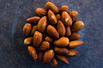 simple food ingredients, salted roasted almonds in clear bowl