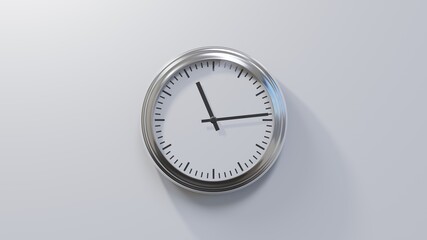 Glossy chrome clock on a white wall at fourteen past eleven. Time is 11:14 or 23:14