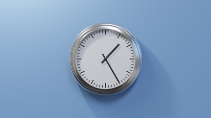 Glossy chrome clock on a blue wall at twenty-five past one. Time is 01:25 or 13:25