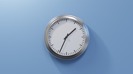 Glossy chrome clock on a blue wall at thirty-four past one. Time is 01:34 or 13:34