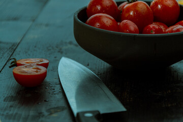 still life with fresh red, green and yellow tomatoes freshly picked from the garden on the wooden...