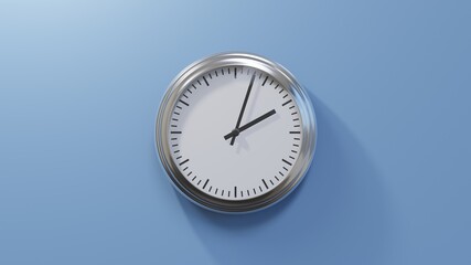 Glossy chrome clock on a blue wall at three past two. Time is 02:03 or 14:03