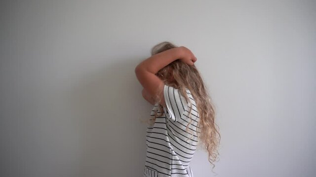 Funny blond girl simper on white wall background. Gimbal motion