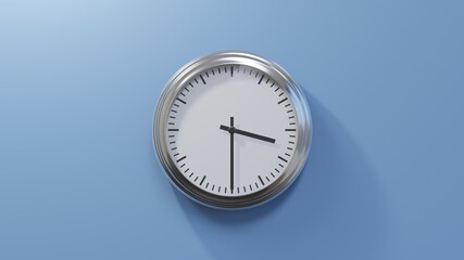 Glossy chrome clock on a blue wall at half past three. Time is 03:30 or 15:30