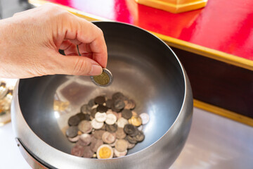 senior buddhist woman donate to the temple in thailand. buddhissm concept