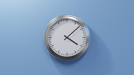 Glossy chrome clock on a blue wall at eight past four. Time is 04:08 or 16:08
