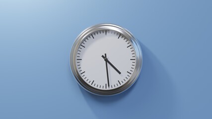 Glossy chrome clock on a blue wall at twenty-nine past four. Time is 04:29 or 16:29