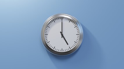 Glossy chrome clock on a blue wall at five o'clock. Time is 05:00 or 17:00