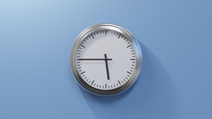 Glossy chrome clock on a blue wall at quarter to six. Time is 05:45 or 17:45