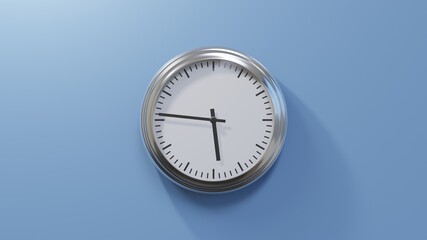Glossy chrome clock on a blue wall at forty-six past five. Time is 05:46 or 17:46