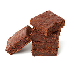 stack of square baked pieces of brownie chocolate cake isolated on a white background