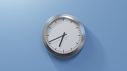 Glossy chrome clock on a blue wall at forty-one past six. Time is 06:41 or 18:41