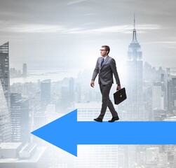 Businessman walking on arrow in business concept