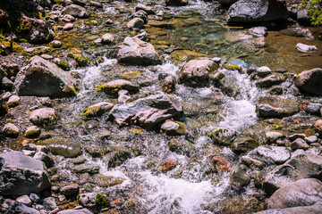 Water churning at the rapids on a small mountain river