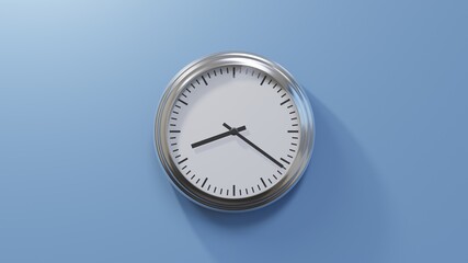 Glossy chrome clock on a blue wall at twenty-one past eight. Time is 08:21 or 20:21