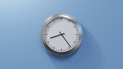 Glossy chrome clock on a blue wall at twenty-four past eight. Time is 08:24 or 20:24