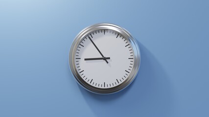 Glossy chrome clock on a blue wall at fifty-four past eight. Time is 08:54 or 20:54