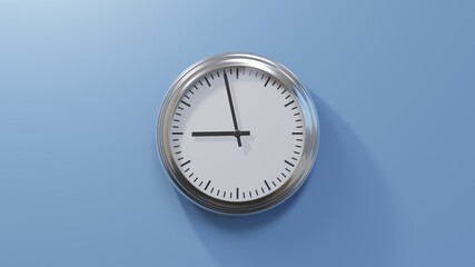 Glossy chrome clock on a blue wall at fifty-eight past eight. Time is 08:58 or 20:58