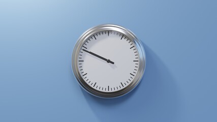 Glossy chrome clock on a blue wall at forty-nine past nine. Time is 09:49 or 21:49