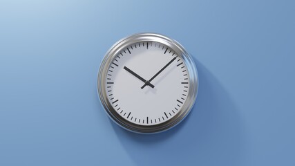 Glossy chrome clock on a blue wall at eight past ten. Time is 10:08 or 22:08