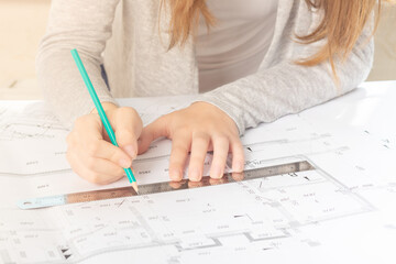 Architecture and construction. The architect works in an office, making a sketch of the interior...