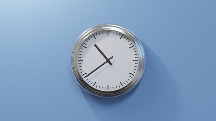 Glossy chrome clock on a blue wall at thirty-nine past ten. Time is 10:39 or 22:39